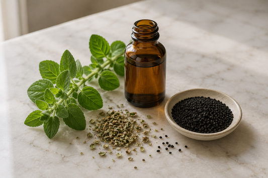 Fresh oregano, dried oregano and black Nigella sativa seeds on marble