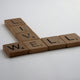 brown wooden letter blocks on white surface