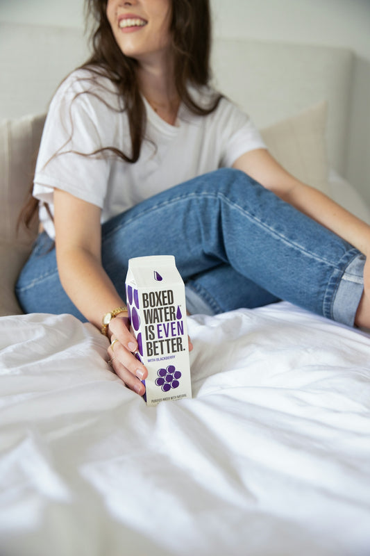 a woman sitting on a bed