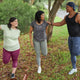 Three people stretch before a run on a rainy day