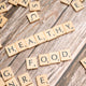 scrabble tiles spelling out the word healthy on a wooden surface