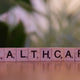 A wooden block that says healthcare on it
