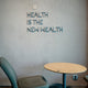 Health is the new wealth, shown near a chair.