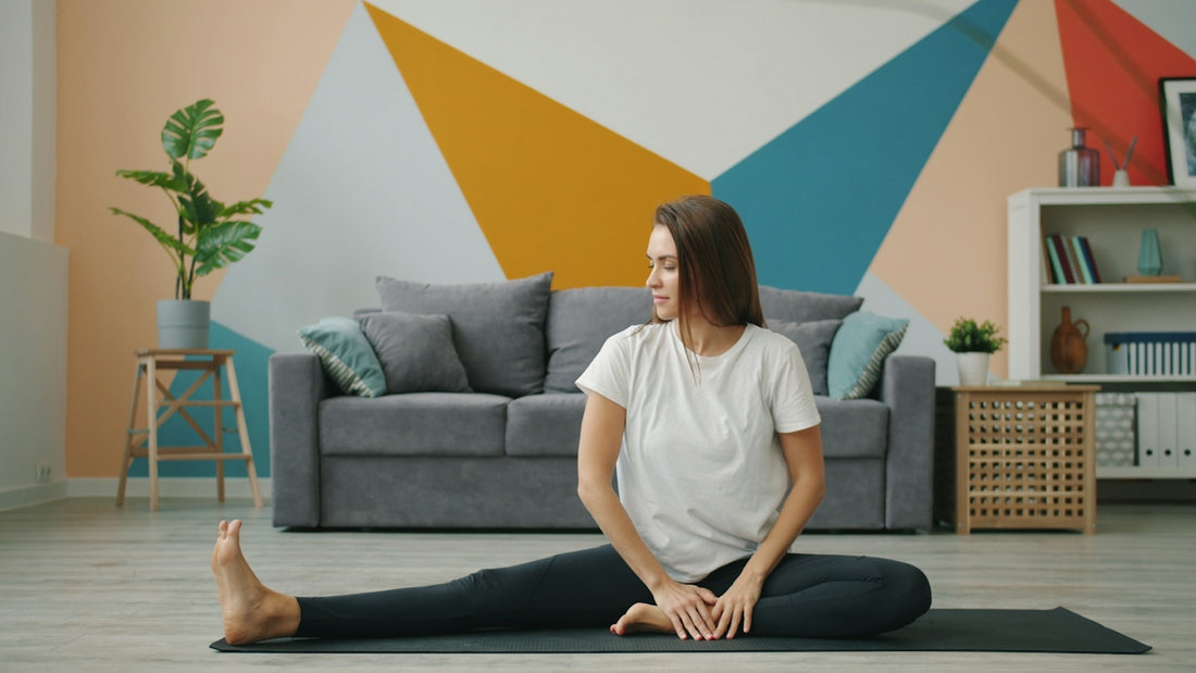 Woman stretching on a yoga mat in living room
