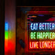 Neon sign reads eat better, be happier, live longer.